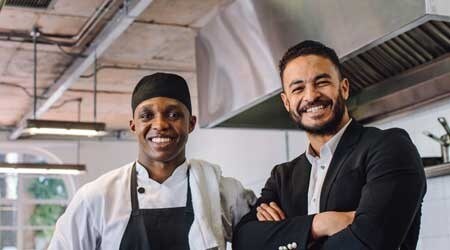 Chef and his boss smiling